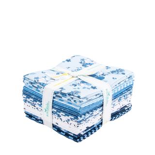 A bundle of folded fabric pieces tied with a white ribbon, featuring a blue and white floral pattern, set against a plain white background.