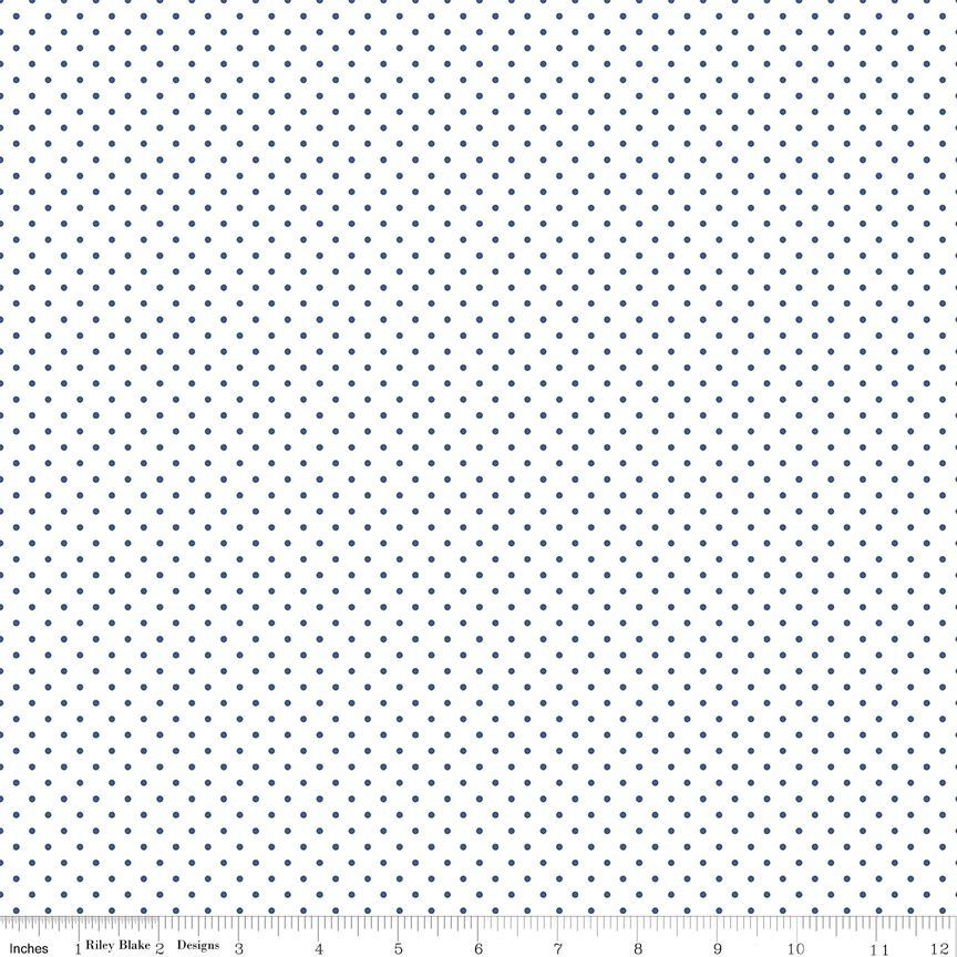A close-up fabric pattern swatch showing a repeating small blue polka dot design on a white background, with a ruler along the bottom edge for scale.