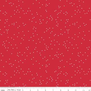 Red fabric with a scattered white blossom pattern, shown with a white ruler at the bottom edge indicating scale.