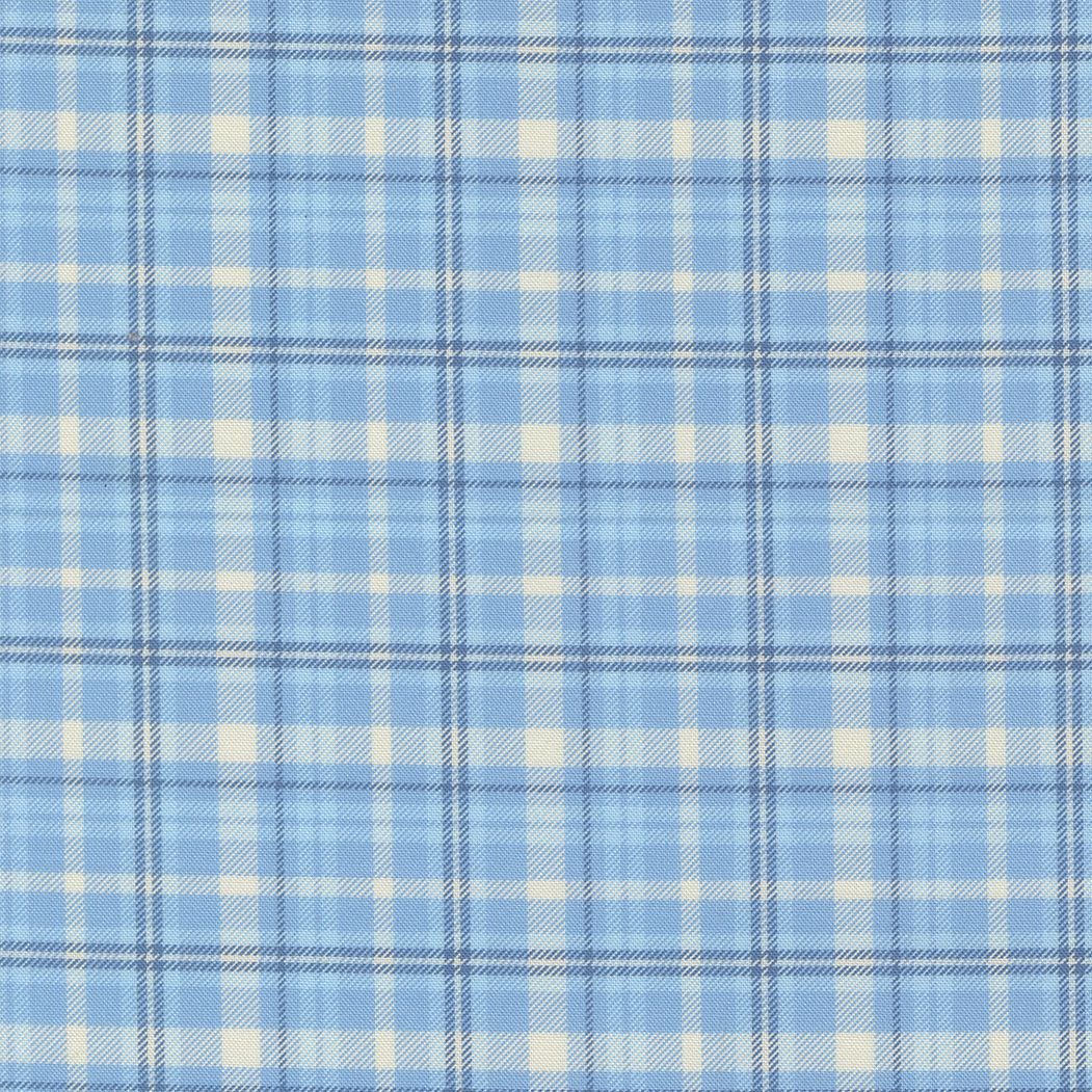 A close-up of a plaid fabric pattern featuring light blue, white, and navy blue intersecting stripes.