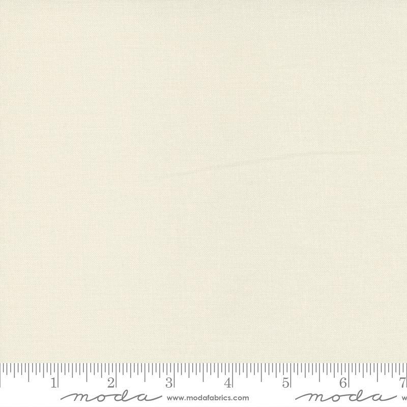 A close-up of a light cream fabric texture with a ruler along the bottom edge showing measurement markings and Modaprint branding.