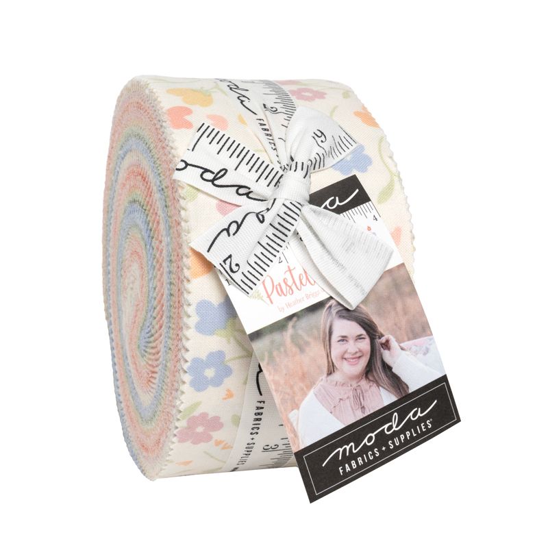 A roll of Moda Fabrics 'Pastel Prairie' jelly roll fabric bundled with a white ribbon and a product tag, shown on a plain white background.