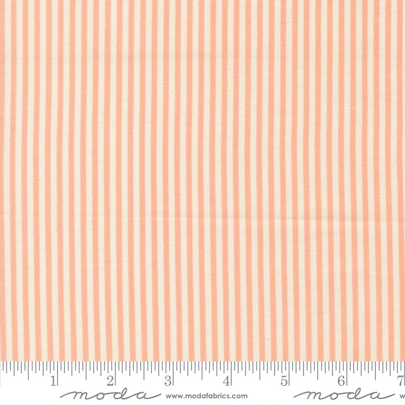 A close-up of a fabric pattern featuring vertical peach and off-white stripes, with a white ruler at the bottom showing measurements and Modas Fabrics branding.