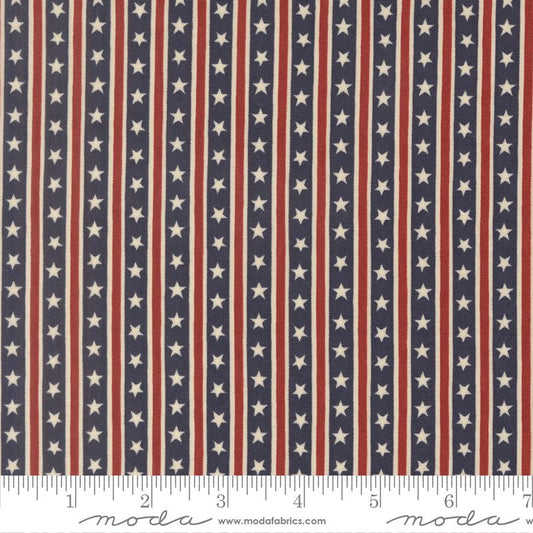 Patriotic American flag fabric pattern with vertical red and white stripes and white stars on a navy blue background, shown with a ruler at the bottom for scale. The brand name 'moda' is visible on the ruler watermark.