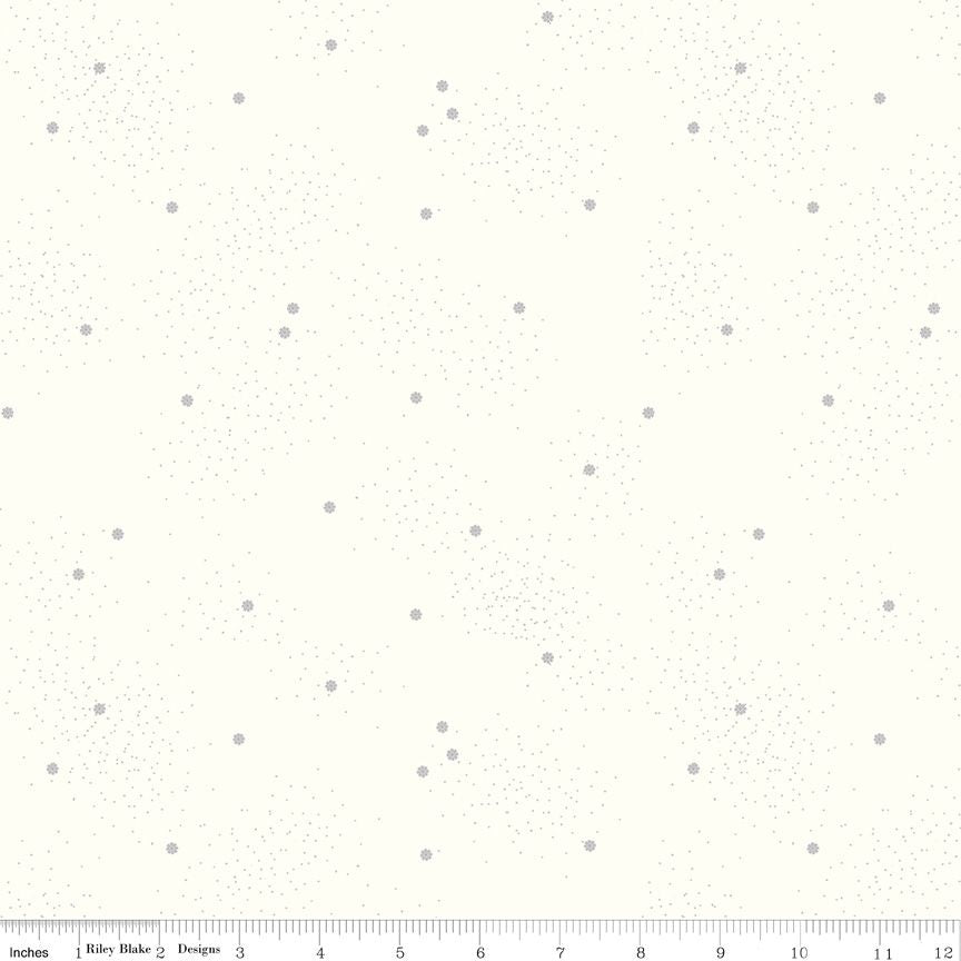 A fabric pattern swatch showing a cream background with scattered small gray daisies and fine speckles, with a ruler scale along the bottom edge.