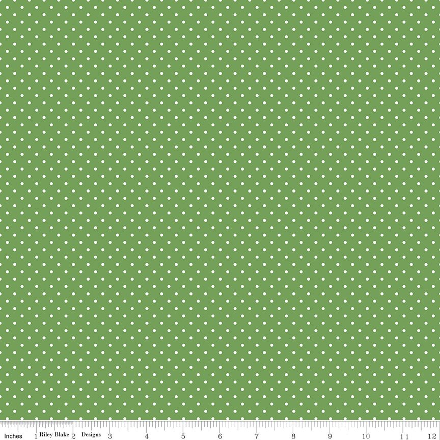 Small white dots on green fabric background