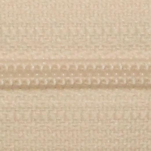 A close-up of a beige zipper.