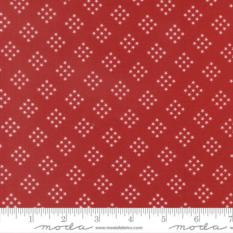 Red fabric with white star pattern and Moda label