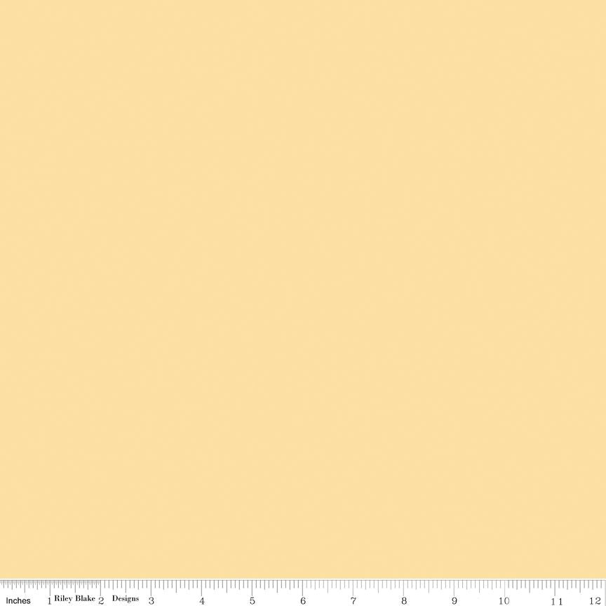 Pale yellow fabric swatch with ruler at bottom for scale.