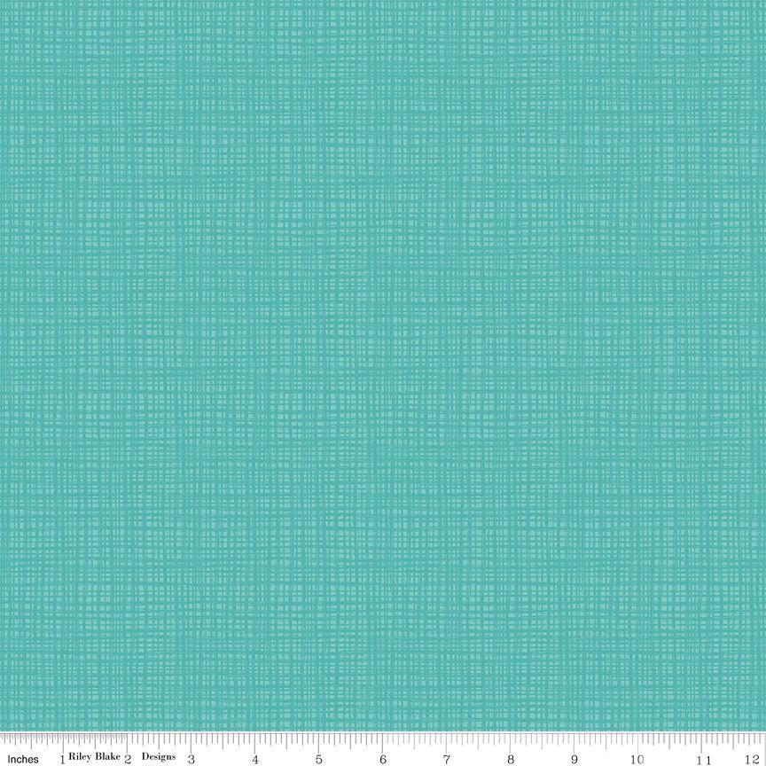 A close-up fabric or material swatch in bright aqua/turquoise with a subtle woven grid texture, shown flat with a ruler along the bottom edge for scale.