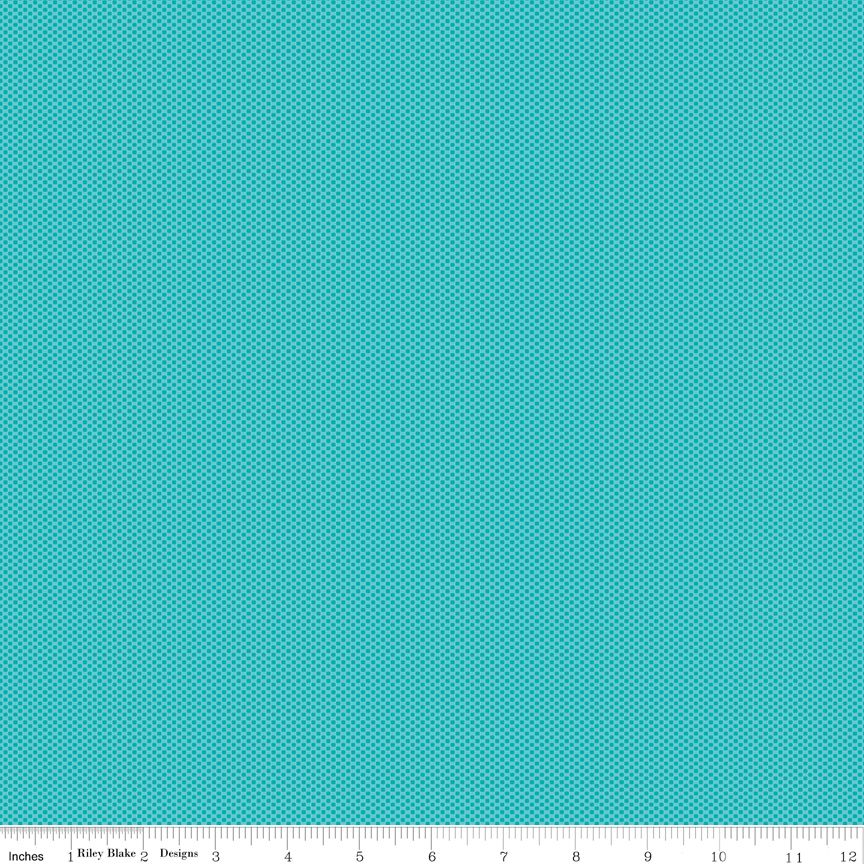 A flat turquoise fabric swatch with a small repeating geometric pattern, shown with a ruler along the bottom edge for scale.