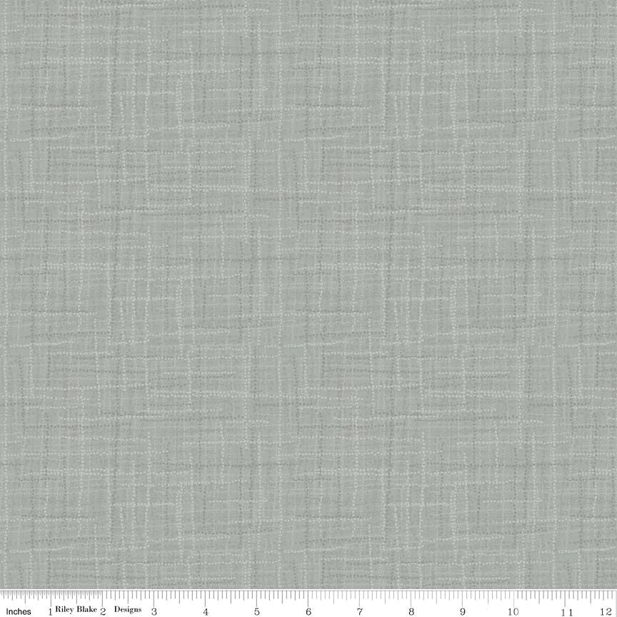 A close-up fabric swatch showing a light gray woven texture with a subtle grid pattern, with a ruler at the bottom indicating scale.