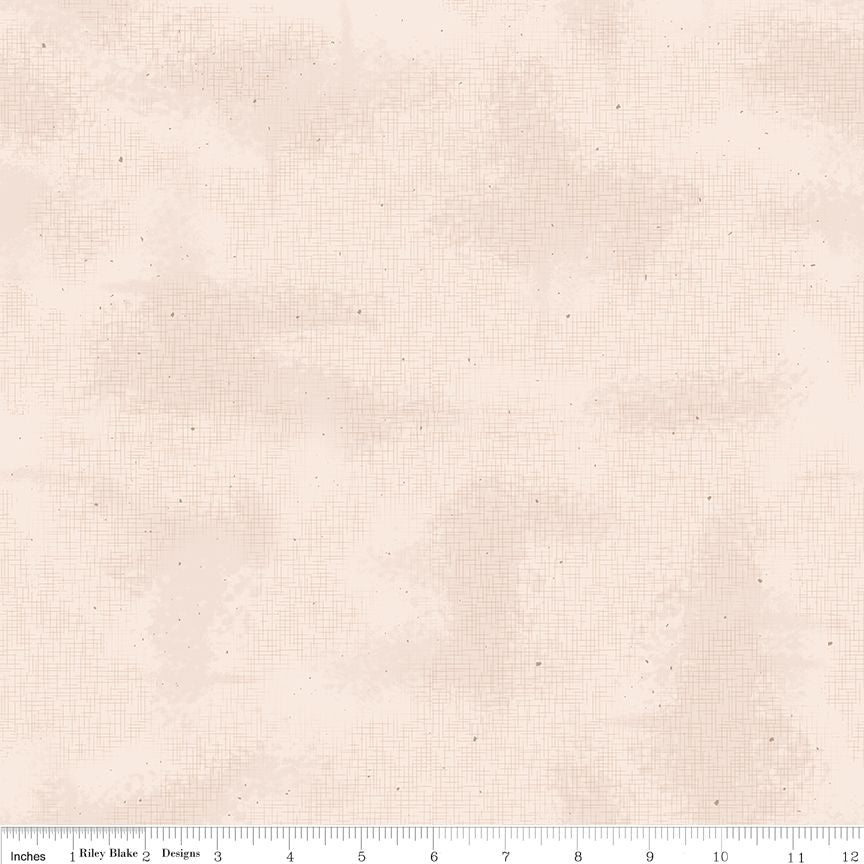 A close-up of a light beige fabric texture with a subtle grid pattern and tiny speckles, shown with a ruler at the bottom indicating scale.
