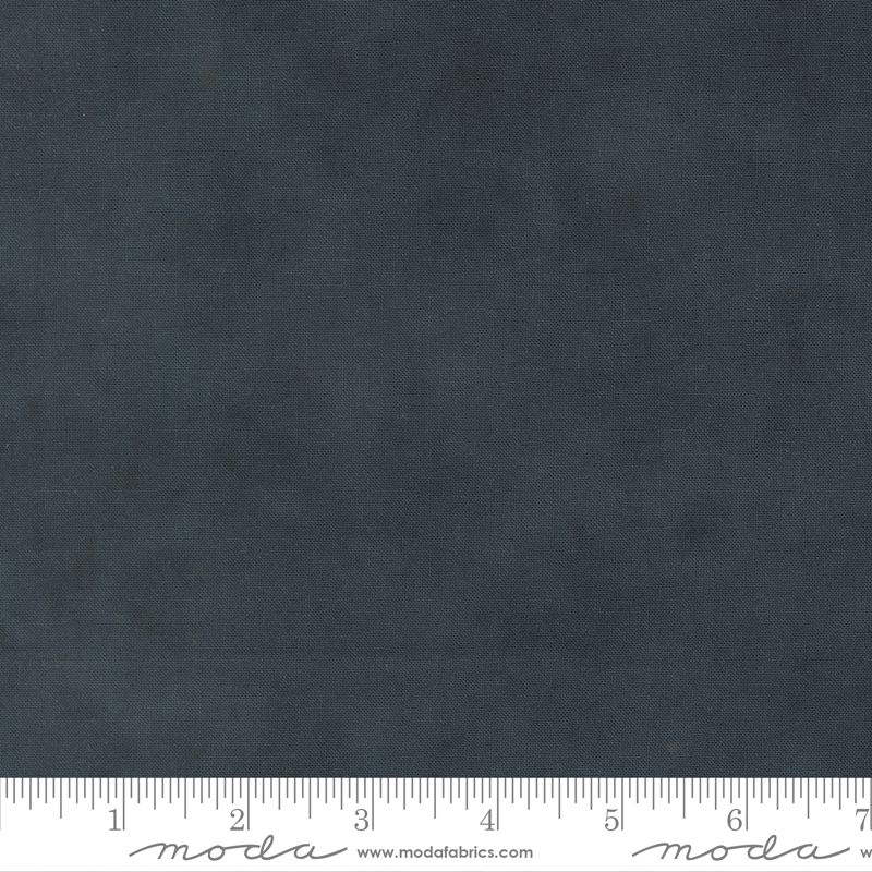 Dark navy mottled fabric texture shown with a measuring ruler along the bottom edge to indicate scale. The brand name 'Moda Fabrics' is printed on the ruler.