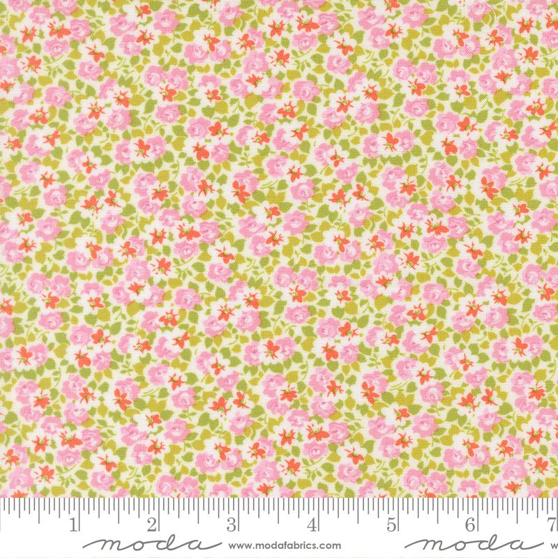 A close-up of a floral fabric pattern with pink flowers and green leaves on a cream background, with a ruler along the bottom edge and a Modas fabric watermark at the bottom.