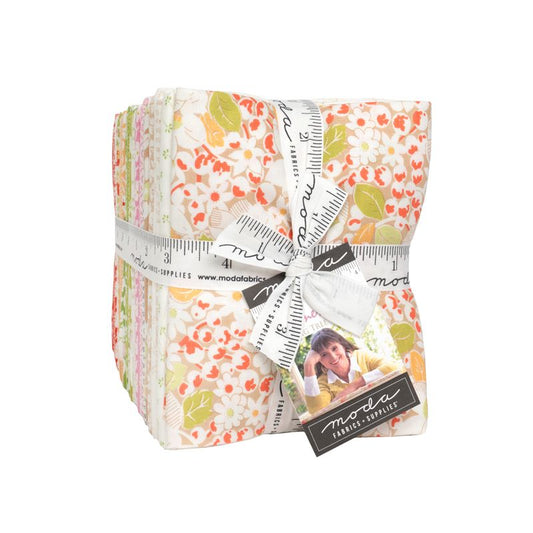 Pack of floral fabric strips with a ruler and Moda label on a white background