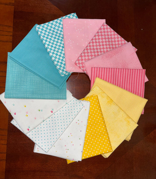A circular arrangement of colorful fabric swatches with various patterns including stripes, polka dots, and checks, displayed on a dark wooden table.