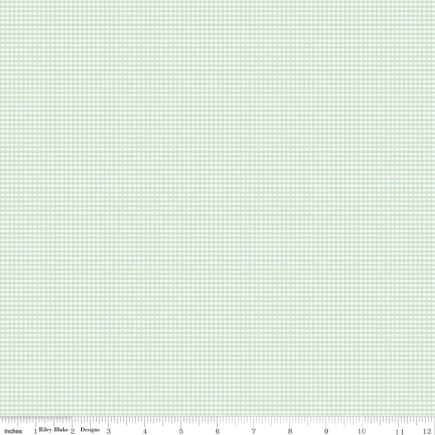 A fabric swatch showing a light mint green and white gingham checkered pattern, with a ruler scale at the bottom indicating inches and a 12-inch width.
