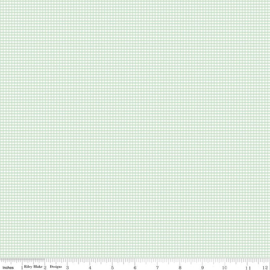A fabric swatch showing a light mint green and white gingham checkered pattern, with a ruler scale at the bottom indicating inches and a 12-inch width.