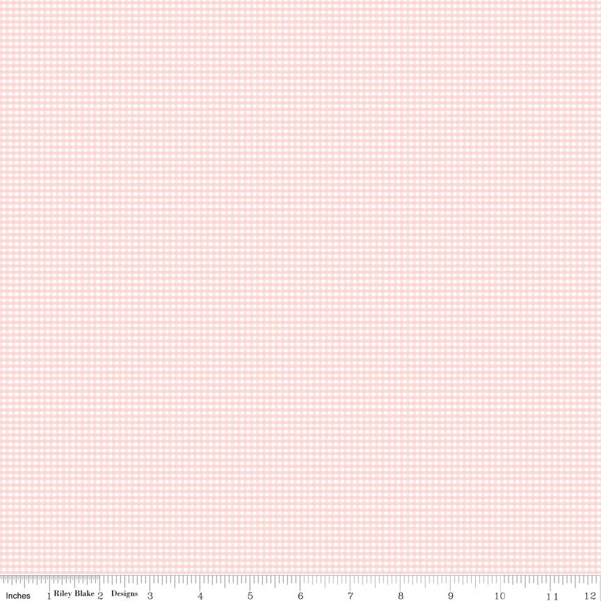 Pink and white gingham fabric with a ruler at the bottom.