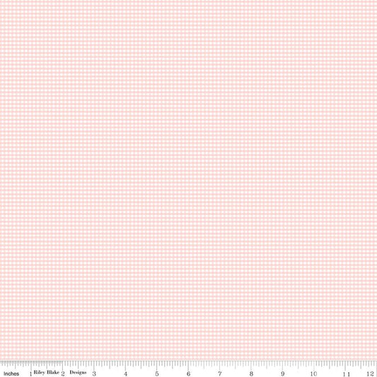 Pink and white gingham fabric with a ruler at the bottom.