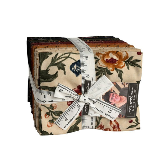 A stack of Moda Fabrics pieced fabric squares wrapped with a white measuring tape and tied with a matching fabric ribbon. The fabric features a vintage floral pattern on a cream background with orange, red, green, and blue flowers.