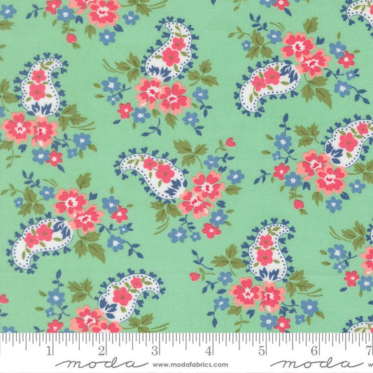 Floral pattern with pink and blue flowers on a mint background