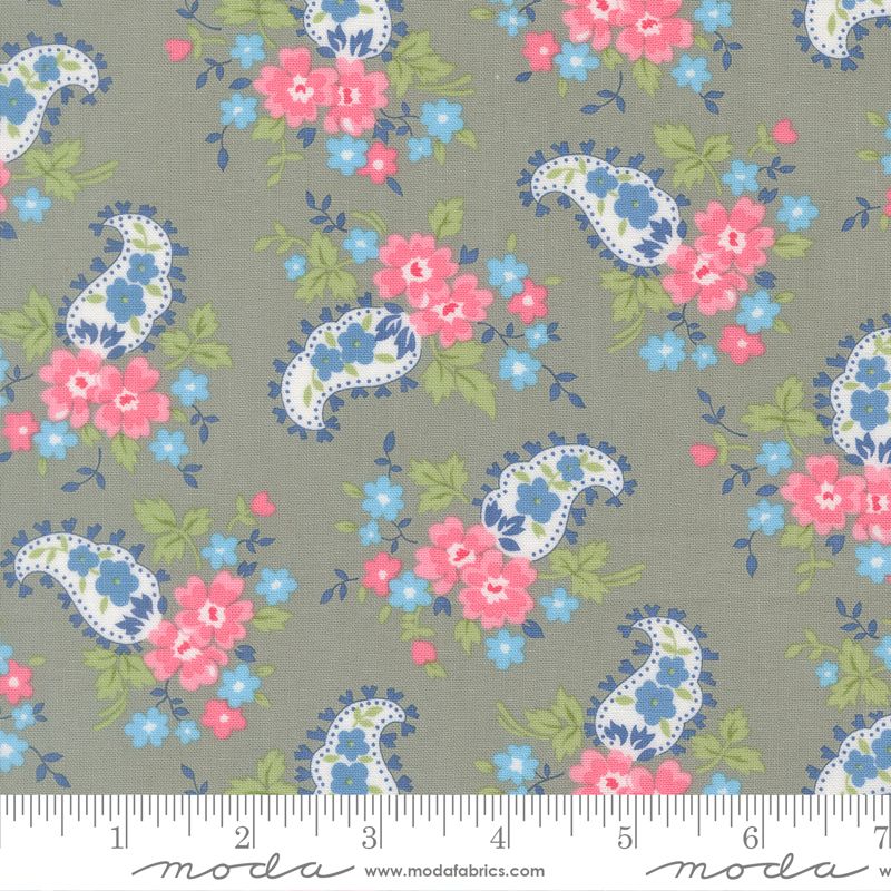 Floral and paisley pattern fabric with a ruler at the bottom