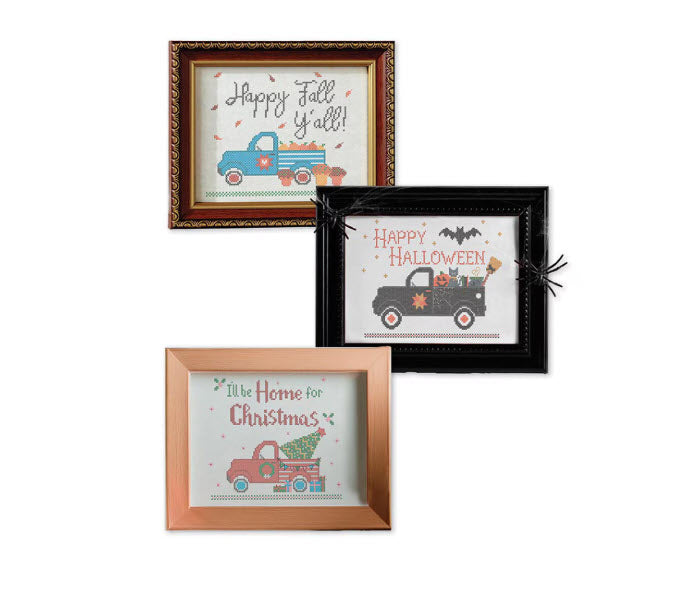 Three framed embroidered prints displayed together on a white background, featuring autumn and holiday themes: 'Happy Fall Y'all!' in a brown frame, 'Happy Halloween' in a black frame with a spider decoration, and 'I'll Be Home for Christmas' in a copper frame.