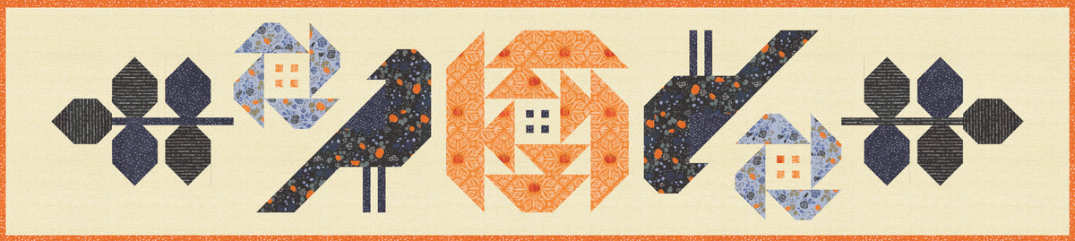 A quilted table runner featuring stylized birds, flowers, and geometric shapes in navy, orange, blue, and cream on a light beige background.