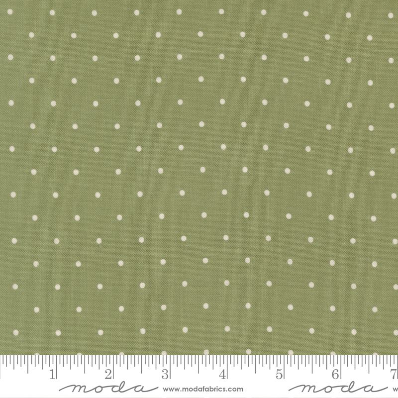 Olive green fabric with a white polka dot pattern, featuring a white ruler at the bottom with Modra branding and website text.