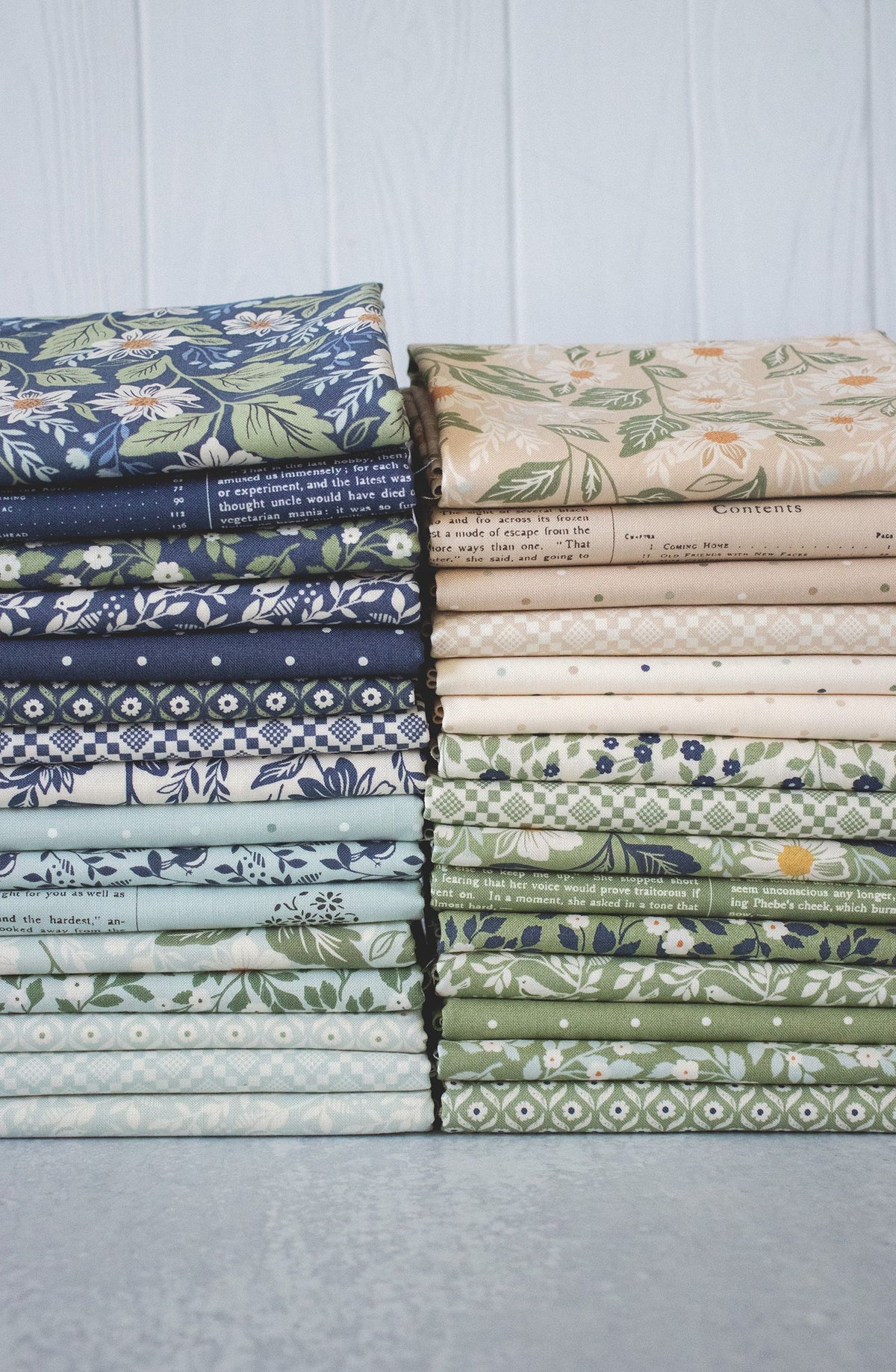 Stacks of folded fabric rwith various patterns on a light background
