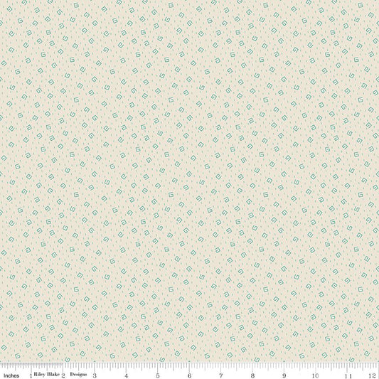 Cream fabric with printed 'doodles" in light blue and a ruler at the bottom.
