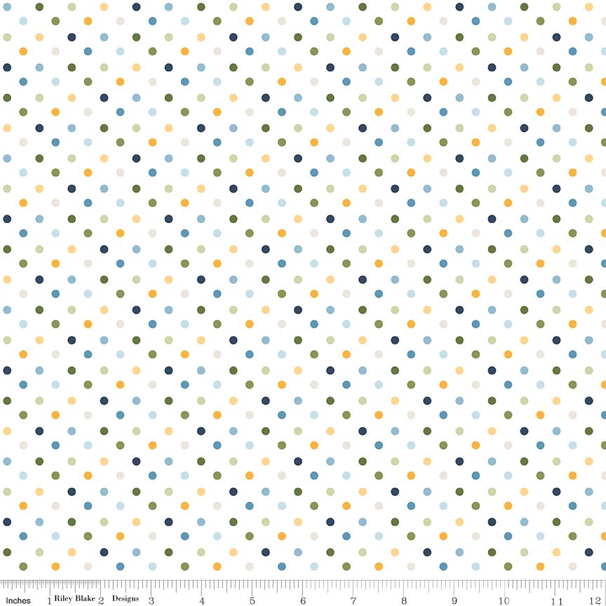 A repeating polka dot pattern on a white fabric background, featuring small dots in navy, olive green, mustard yellow, light blue, and pale pink. A ruler at the bottom indicates the scale of the pattern.