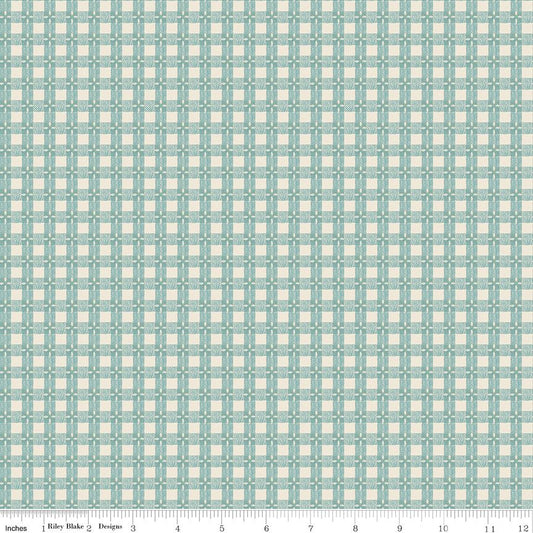 A repeating geometric pattern fabric swatch in light blue and cream, with a ruler scale along the bottom edge showing inches.