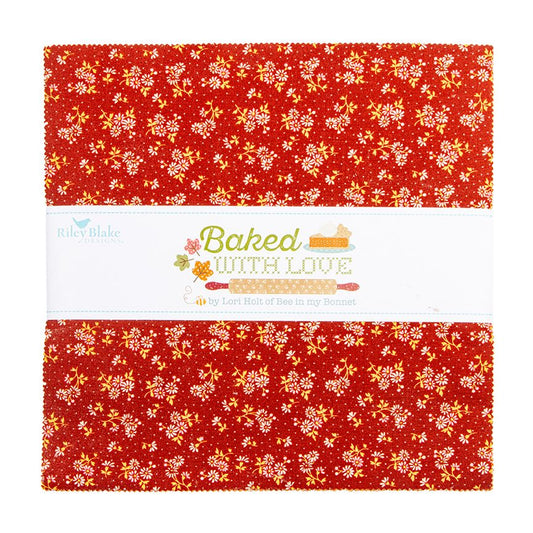 A layer cake showing a piece of red fabric with a dense white and yellow floral pattern, wrapped in a white paper band that reads 'Baked with Love' and shows the Riley Blake Designs brand logo.
