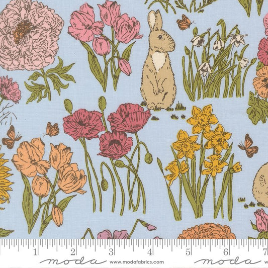 Fabric pattern with flowers, a rabbit, and butterflies on a blue background with Moda label.