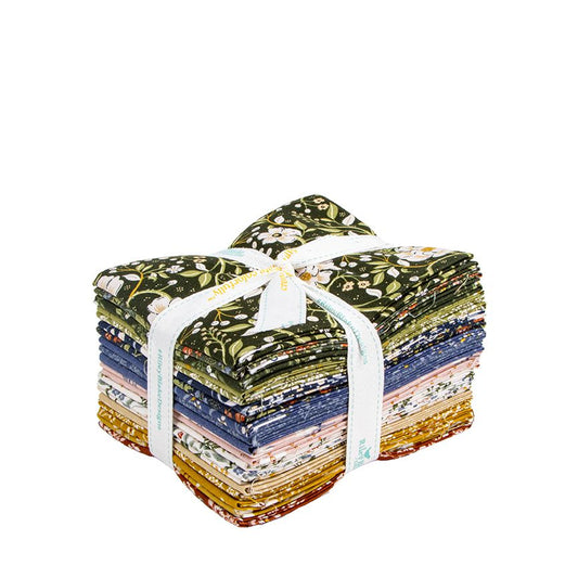 A fat quarter bundle tied with a white ribbon, showing a variety of floral and patterned designs in green, blue, pink, white, and gold, on a solid white background.