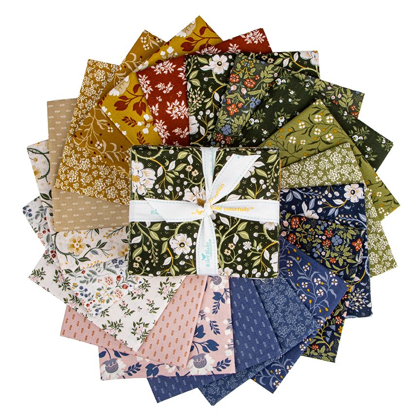 A fat quarter bundle arranged in a circular stack, tied with a white ribbon. The fabrics feature various floral, botanical, and patterned designs in green, blue, pink, yellow, and brown tones on a solid white background.
