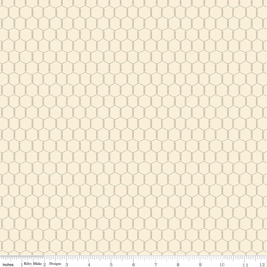 Cream fabric with gray chicken wire pattern and a ruler at the bottom for scale.