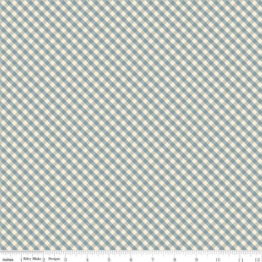 A close-up of a gingham fabric pattern with a diagonal check design in muted blue and cream, featuring a measurement ruler at the bottom indicating 12 inches.