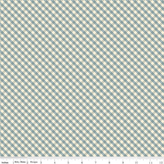 A close-up of a gingham fabric pattern with a diagonal check design in muted blue and cream, featuring a measurement ruler at the bottom indicating 12 inches.