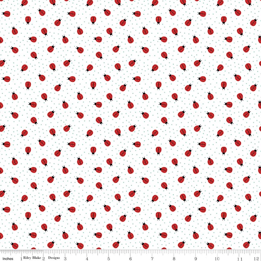 A repeating pattern of red ladybugs with black heads and legs on a white background with tiny blue-gray dots. A ruler along the bottom edge shows the scale of the print.