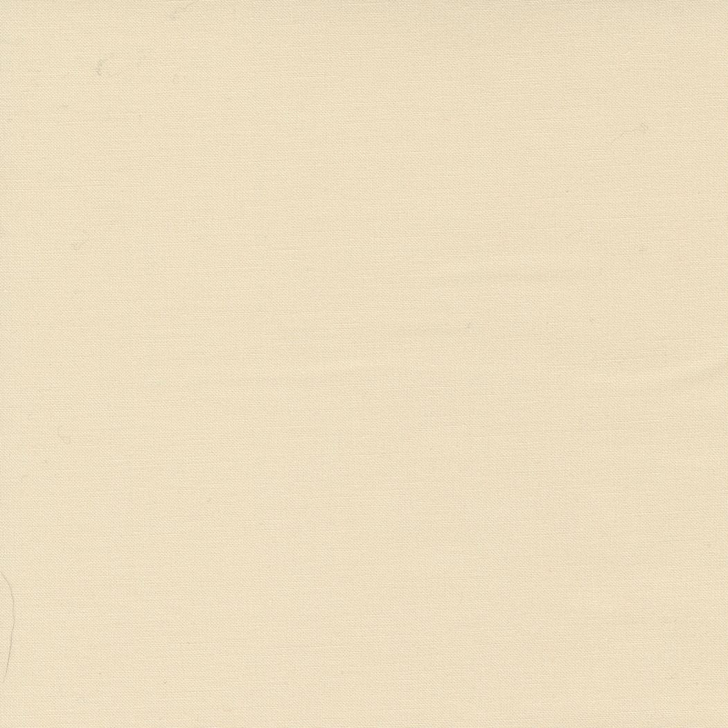A close-up of a solid warm cream or off-white fabric