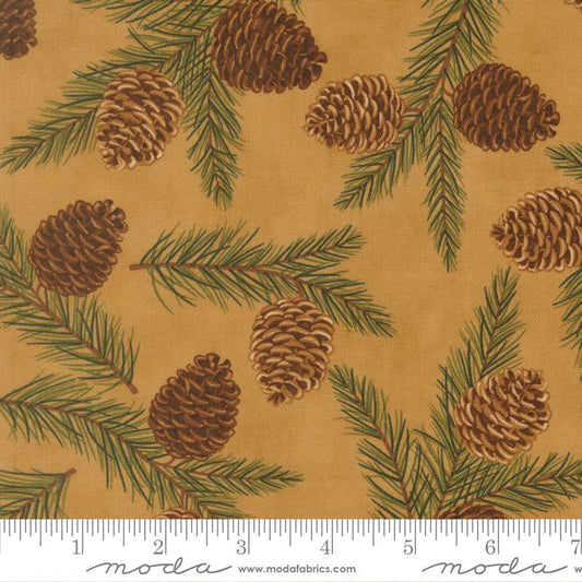 Fabric with pine cones and branches pattern on a beige background, featuring Moda label.