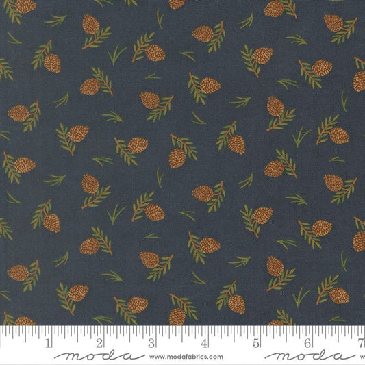 Fabric pattern with pinecones and leaves on a dark blue background, featuring Moda label.