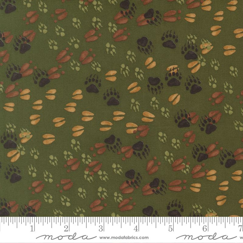 Pattern of animal tracks on a green background with a Moda label at the bottom.