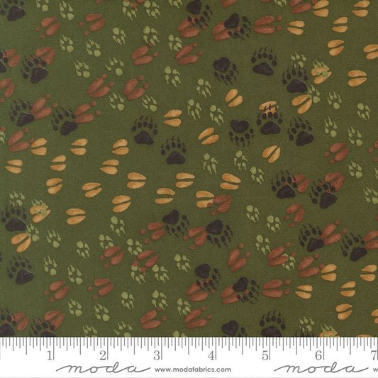 Pattern of animal tracks on a green background with a Moda label at the bottom.