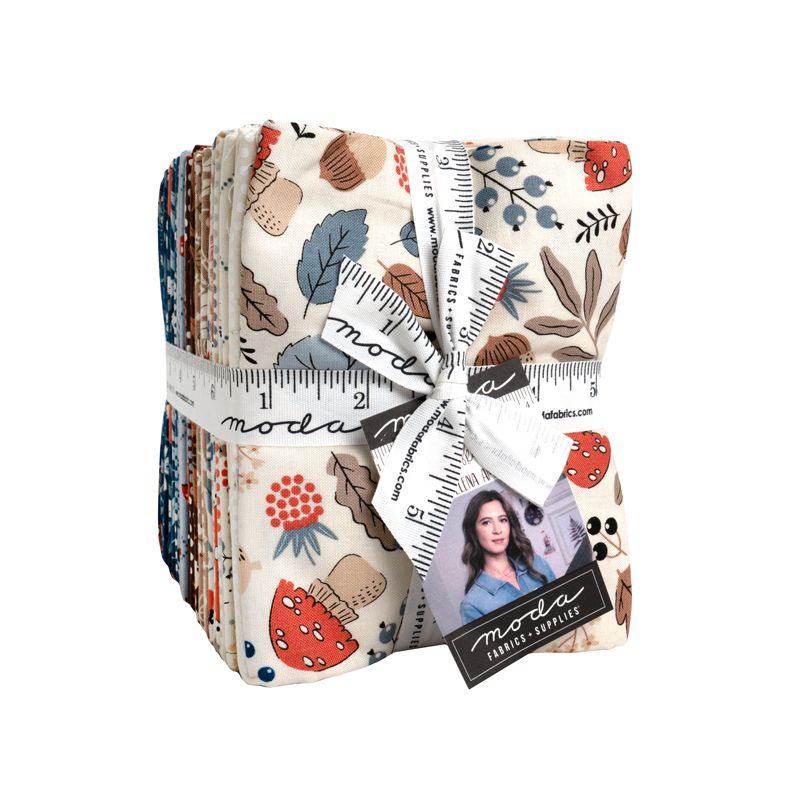 Pack of fat quarters with floral and leaf patterns, tied with a ruler, on a white background.