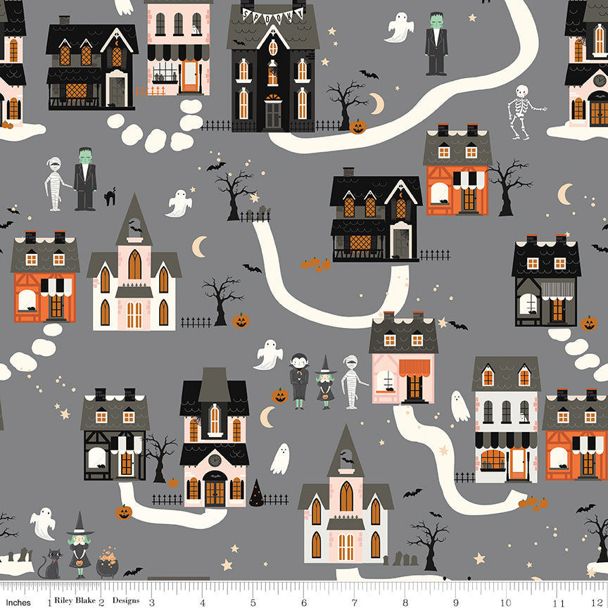 Halloween-themed fabric with houses, ghosts, and pumpkins on a gray background.
